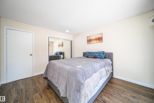Room featuring wood-finish flooring, light-toned walls, a white ceiling, and white trim - 5303 21 Avenue, Edmonton, AB - Indoor Photo Showing Bedroom