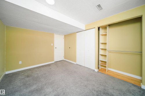 Room featuring textured carpet flooring, light yellow painted walls, and white trim - 5303 21 Avenue, Edmonton, AB - Indoor Photo Showing Other Room