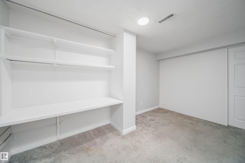 Built-in shelving and desk area with white finishes - 5303 21 Avenue, Edmonton, AB - Indoor