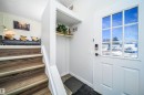 Entryway featuring a white paneled door with a multi-pane window, smart lock hardware, and a built-in coat nook with a wood shelf - 5303 21 Avenue, Edmonton, AB  - Indoor Photo Showing Other Room 