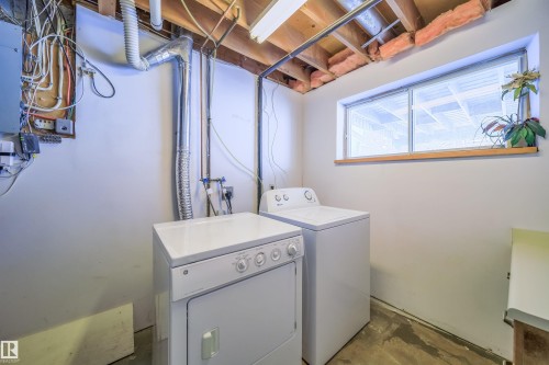 Dedicated laundry area featuring a window, exposed ceiling joists, and a concrete floor - 5303 21 Avenue, Edmonton, AB - Indoor Photo Showing Laundry Room