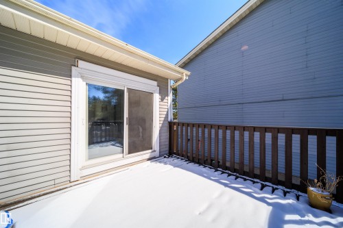 Outdoor deck featuring a wood railing and sliding glass door access - 5303 21 Avenue, Edmonton, AB - Outdoor With Exterior