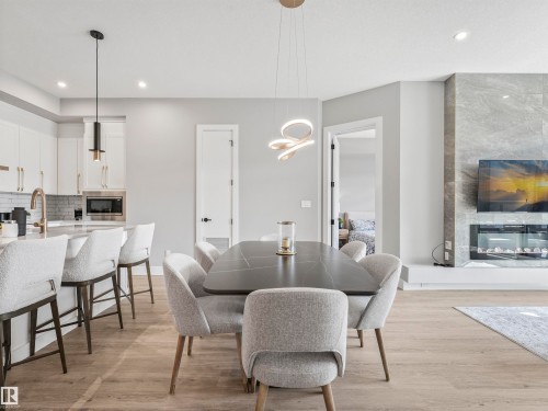101 7471 May Common, Edmonton, AB - Indoor Photo Showing Dining Room With Fireplace
