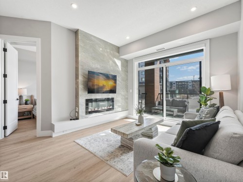 101 7471 May Common, Edmonton, AB - Indoor Photo Showing Living Room With Fireplace