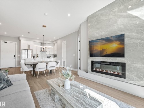 101 7471 May Common, Edmonton, AB - Indoor Photo Showing Living Room With Fireplace