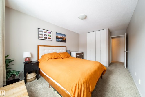 Carpeted bedroom with neutral wall tones - 220 14819 51 Avenue, Edmonton, AB - Indoor Photo Showing Bedroom