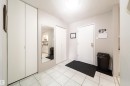 Entryway featuring white square tile flooring, a flush-mount ceiling light fixture, and light gray wall paint - 220 14819 51 Avenue, Edmonton, AB  - Indoor Photo Showing Other Room 