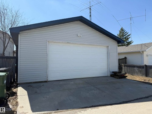 Detached garage featuring light gray siding and a dark roofline - 73 Birchmont Drive, Leduc, AB - Outdoor With Exterior