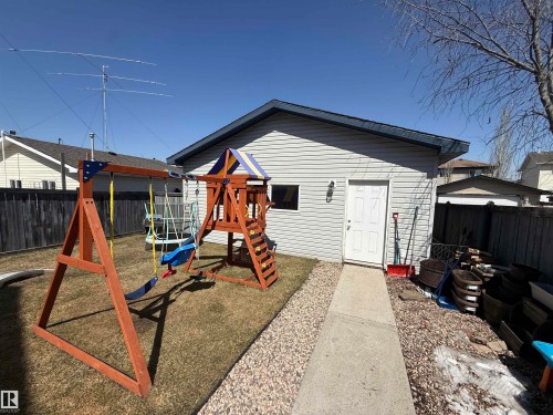 Detached garage with horizontal siding, a side entry door, and a single window - 73 Birchmont Drive, Leduc, AB - Outdoor With Exterior