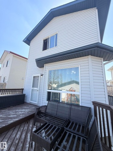 Two-story siding exterior with dark eaves and gutters - 73 Birchmont Drive, Leduc, AB - Outdoor With Deck Patio Veranda With Exterior