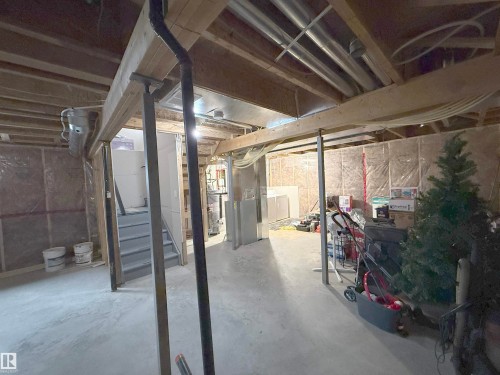 Unfinished basement space featuring exposed wood framing, concrete flooring, and visible ductwork - 3609 Weidle Bend Bend, Edmonton, AB - Indoor Photo Showing Basement
