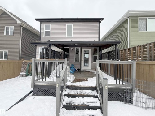 Rear exterior featuring a multi-level wood deck with black railings, leading to a covered patio area - 3609 Weidle Bend Bend, Edmonton, AB - Outdoor With Deck Patio Veranda With Exterior