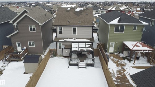 Fenced backyard featuring a wooden deck, covered patio area, and storage shed - 3609 Weidle Bend Bend, Edmonton, AB - Outdoor