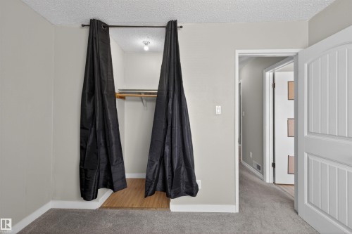 Recessed closet space featuring wood-finish flooring and an overhead light fixture - 11 Greenfield Estates, St. Albert, AB - Indoor