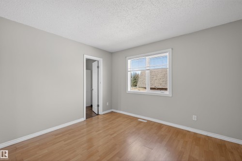 Room with light wood-finish flooring, light grey painted walls, and white trim - 11 Greenfield Estates, St. Albert, AB - Indoor Photo Showing Other Room