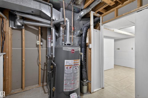 Utility area featuring a water heater, exposed ductwork, and exposed ceiling joists - 11 Greenfield Estates, St. Albert, AB - Indoor Photo Showing Basement