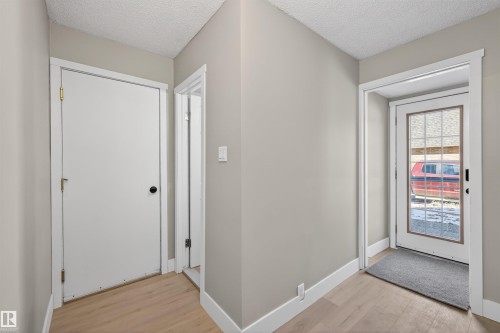 Entryway featuring wood-finish flooring, light grey painted walls, and white trim - 11 Greenfield Estates, St. Albert, AB - Indoor Photo Showing Other Room