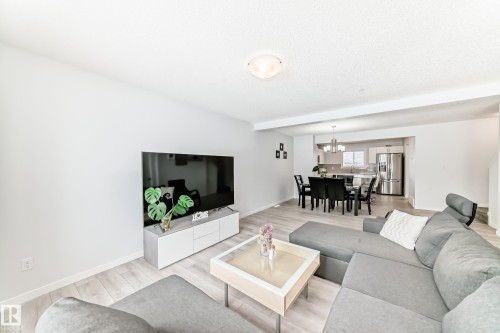 Living area featuring light wood-finish flooring, recessed lighting, and a neutral wall palette - 2505 14 Avenue, Edmonton, AB - Indoor Photo Showing Living Room