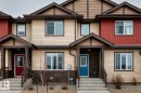Townhome exterior featuring varied siding materials including beige horizontal siding, red vertical siding, and dark brown accents - 2505 14 Avenue, Edmonton, AB  - Outdoor With Facade 
