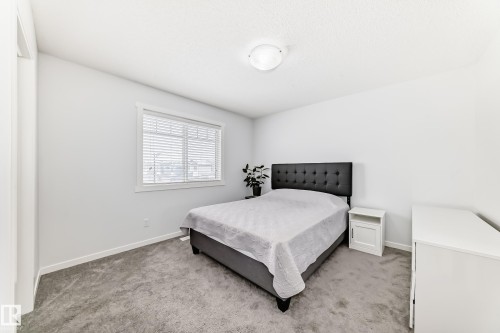 Neutral color palette featuring light gray walls, white trim, and gray carpet flooring - 2505 14 Avenue, Edmonton, AB - Indoor Photo Showing Bedroom