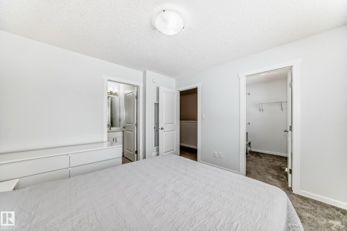 Bedroom featuring light gray wall paint, white trim, and a ceiling-mounted light fixture - 2505 14 Avenue, Edmonton, AB - Indoor Photo Showing Bedroom