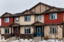 Contemporary townhome exterior featuring multi-toned siding, dark trim accents, and a stone facade - 2505 14 Avenue, Edmonton, AB  - Outdoor With Facade 