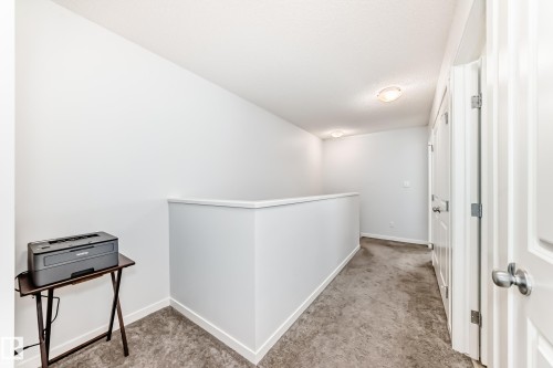 Upper-level hallway featuring neutral wall paint, white trim, and gray carpet flooring - 2505 14 Avenue, Edmonton, AB - Indoor Photo Showing Other Room