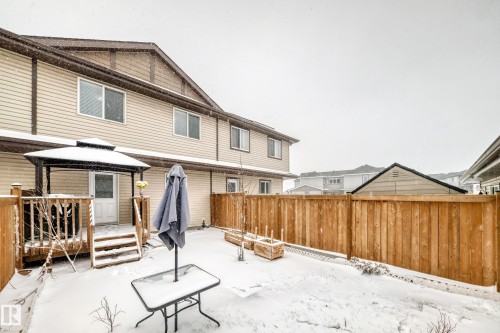 Fenced backyard featuring a wooden deck with a gazebo, direct access to the interior, and a perimeter wood fence - 2505 14 Avenue, Edmonton, AB - Outdoor