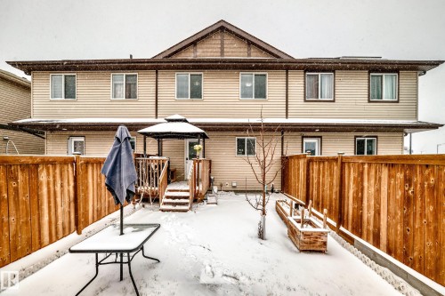 Rear exterior featuring light-toned horizontal siding and dark trim - 2505 14 Avenue, Edmonton, AB - Outdoor With Exterior