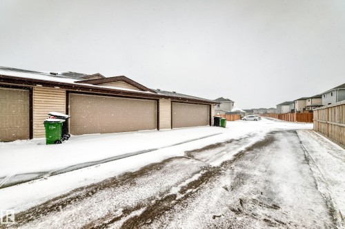 Multi-car garage featuring light-colored horizontal siding and brown trim - 2505 14 Avenue, Edmonton, AB - Outdoor With Exterior