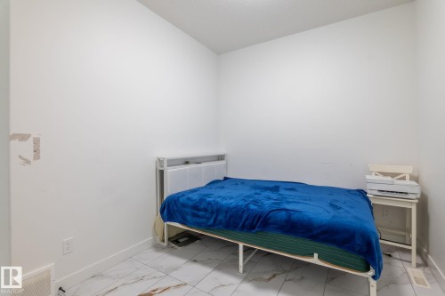 Room featuring white walls and white baseboards - 6607 50A Avenue, Beaumont, AB - Indoor Photo Showing Bedroom
