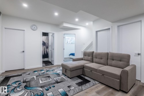 Recessed lighting illuminating wood-finish flooring - 6607 50A Avenue, Beaumont, AB - Indoor