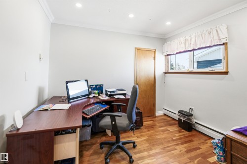 Room with wood-finish flooring, recessed ceiling lighting, crown molding, and a paneled door - 3920 35A Avenue, Red Deer, AB - Indoor Photo Showing Office