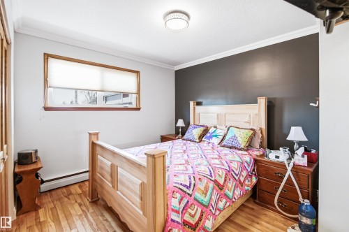 Hardwood flooring throughout featuring a window with wood trim - 3920 35A Avenue, Red Deer, AB - Indoor Photo Showing Bedroom