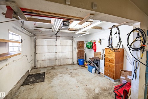 Attached garage featuring a concrete floor, a single garage door, and an interior access door - 3920 35A Avenue, Red Deer, AB - Indoor Photo Showing Garage