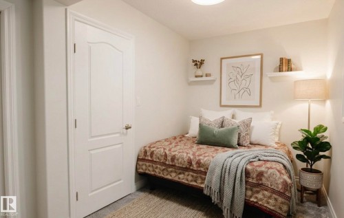 Guest bedroom- Virtually staged-Interior room with light-toned walls and a paneled door - 5701 Rue Eaglemont, Beaumont, AB - Indoor Photo Showing Bedroom
