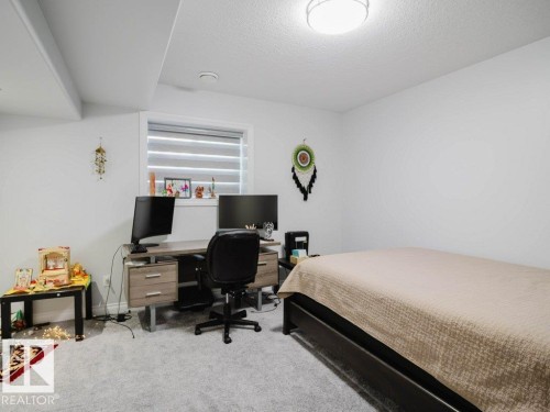 Room with light gray carpeting and white walls - 5701 Rue Eaglemont, Beaumont, AB - Indoor Photo Showing Bedroom