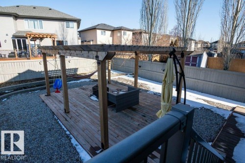 Multi-level deck featuring a wooden pergola and gravel landscaping - 5701 Rue Eaglemont, Beaumont, AB - Outdoor