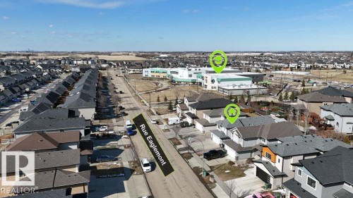 Contemporary residential area featuring multiple detached and attached homes - 5701 Rue Eaglemont, Beaumont, AB - Outdoor With View