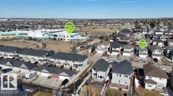 Residential neighborhood with varied architectural styles and a large institutional building visible in the background - 