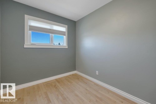 Windowed room with light wood-finish flooring, white baseboards, and a white window frame - 10633 St Gabriel School Road, Edmonton, AB - Indoor Photo Showing Other Room