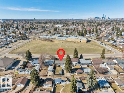 Aerial view showcasing a residential neighborhood with distant city skyline - 10633 St Gabriel School Road, Edmonton, AB - Outdoor With View