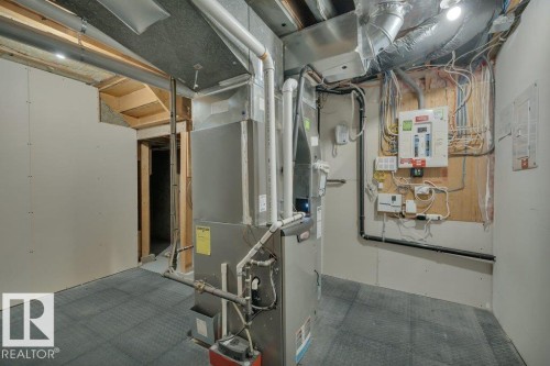 Utility room with furnace, exposed ductwork, and electrical panel - 10633 St Gabriel School Road, Edmonton, AB - Indoor Photo Showing Basement