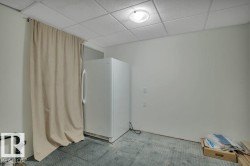 Utility area with a drop ceiling and flush-mount lighting - 
