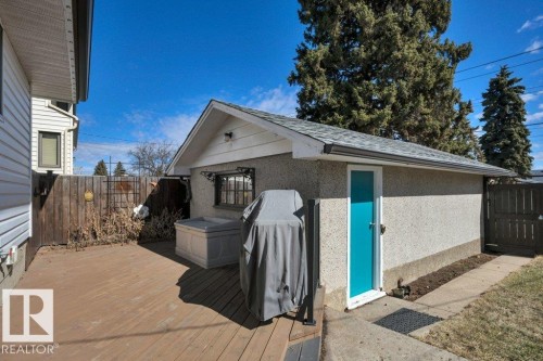 Detached garage with stucco exterior and a vibrant turquoise door - 10633 St Gabriel School Road, Edmonton, AB - Outdoor With Deck Patio Veranda With Exterior