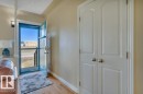 Entryway featuring a blue storm door, light wood-finish flooring, and two white panel doors with brushed nickel hardware - 10633 St Gabriel School Road, Edmonton, AB  - Indoor Photo Showing Other Room 
