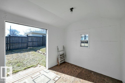 Interior space featuring white walls, plywood flooring, and a single window - 10633 St Gabriel School Road, Edmonton, AB - Indoor Photo Showing Other Room