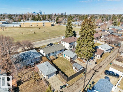 Aerial perspective showcasing a residential area with a prominent school building and athletic field - 10633 St Gabriel School Road, Edmonton, AB - Outdoor With View