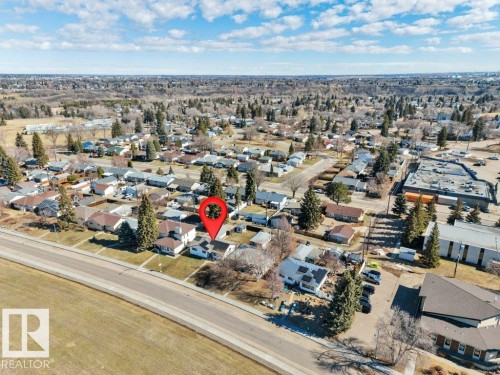 Residential property situated within a neighborhood featuring established trees and varied rooflines - 10633 St Gabriel School Road, Edmonton, AB - Outdoor With View