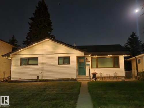White siding exterior with a dark roof and a teal entry door - 10633 St Gabriel School Road, Edmonton, AB - Outdoor